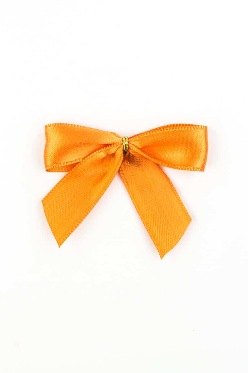 Finished bow made of 15 mm satin ribbon, orange, with adhesive dot