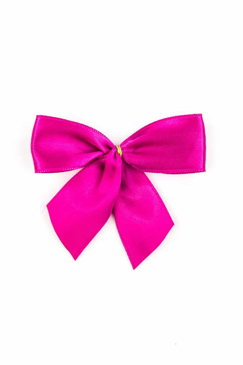 Finished bow made of 25 mm satin ribbon, pink, with adhesive dot